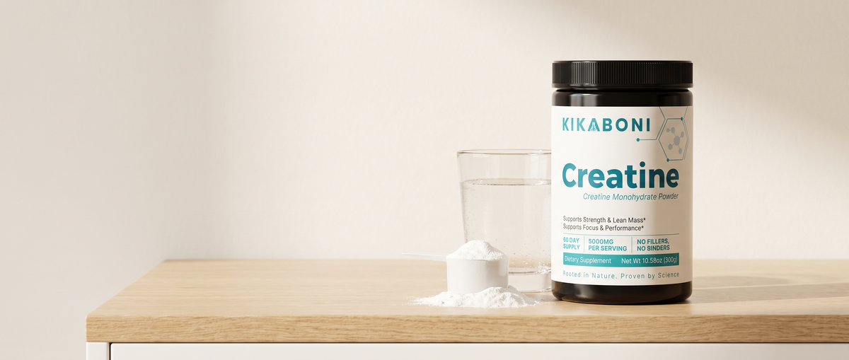 Kikaboni Creatine Monohydrate Powder tub with a scoop of powder and a glass of water